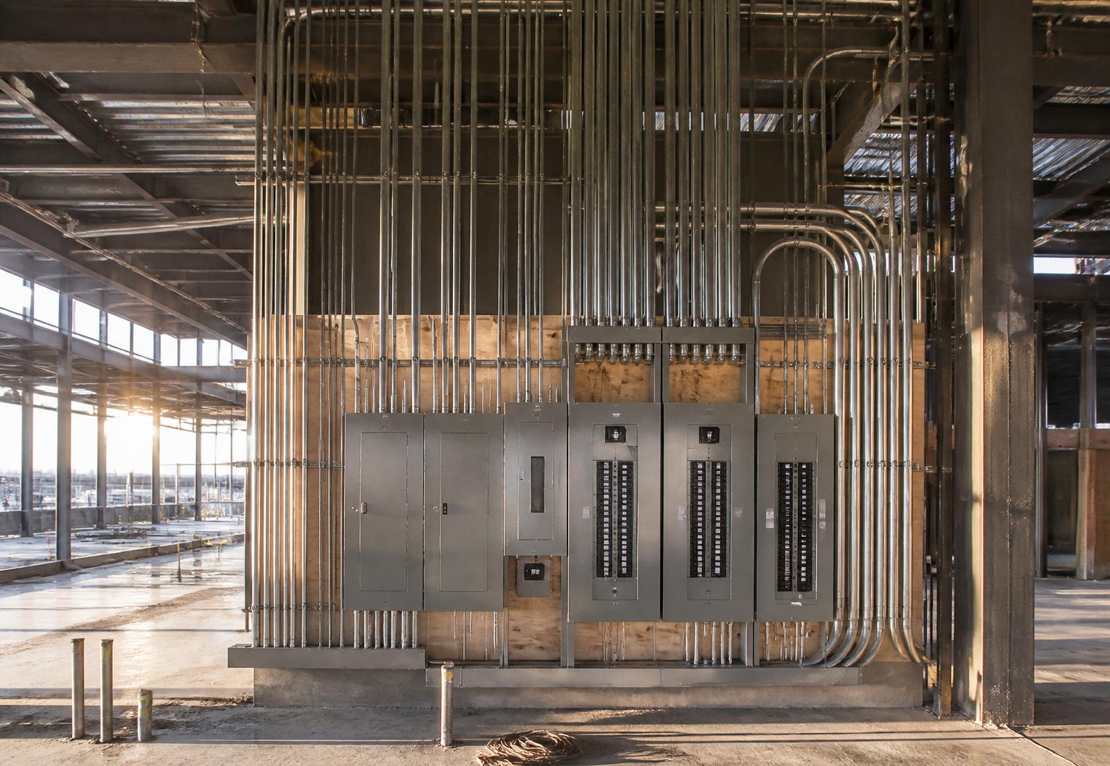 Commercial electrical rough-in with conduit runs and panelboards