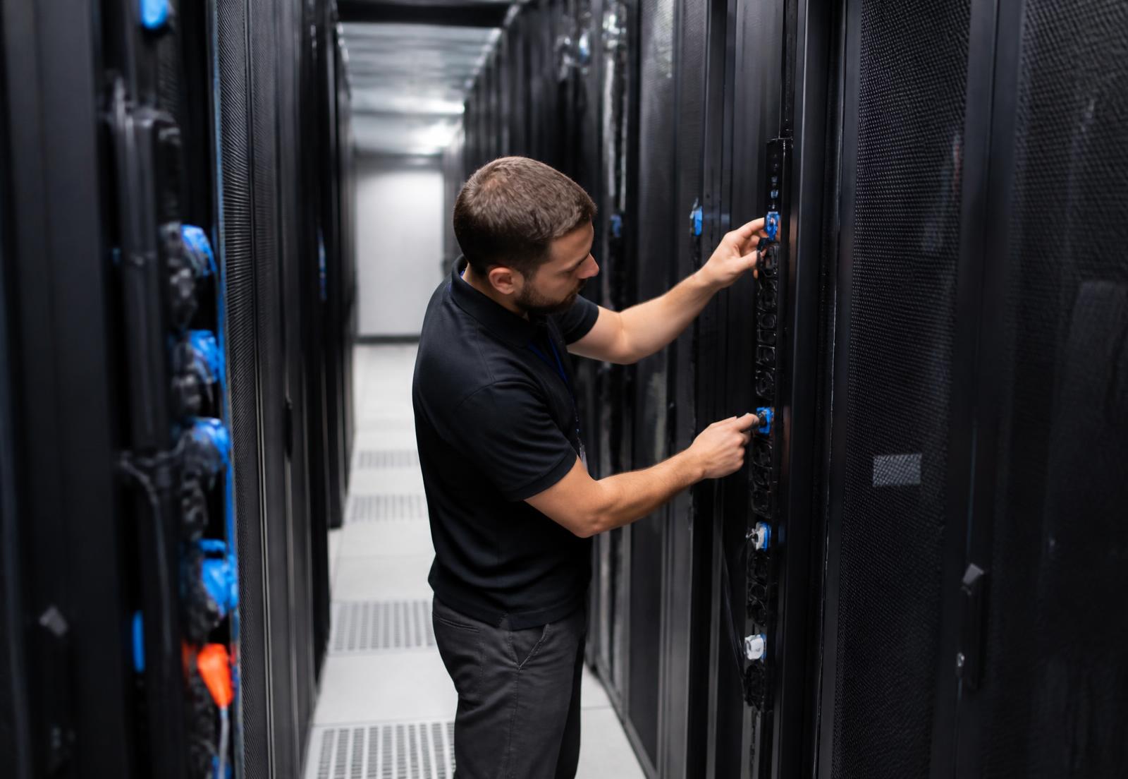Technician working on power distribution in a live data hall
